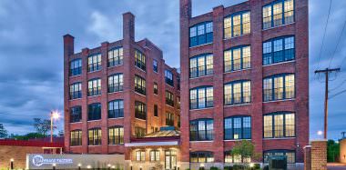 Carriage Factory Apartments Exterior at Dusk