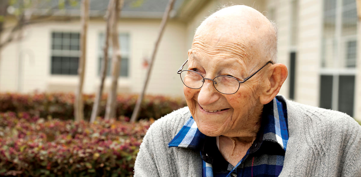 Smiling Elderly Man with Glasses Outdoors