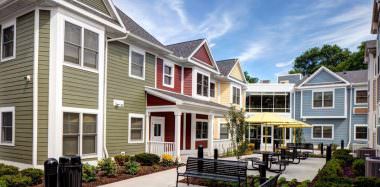 Neighborhood of the Arts Apartments Exterior Courtyard Yellow Umbrellas