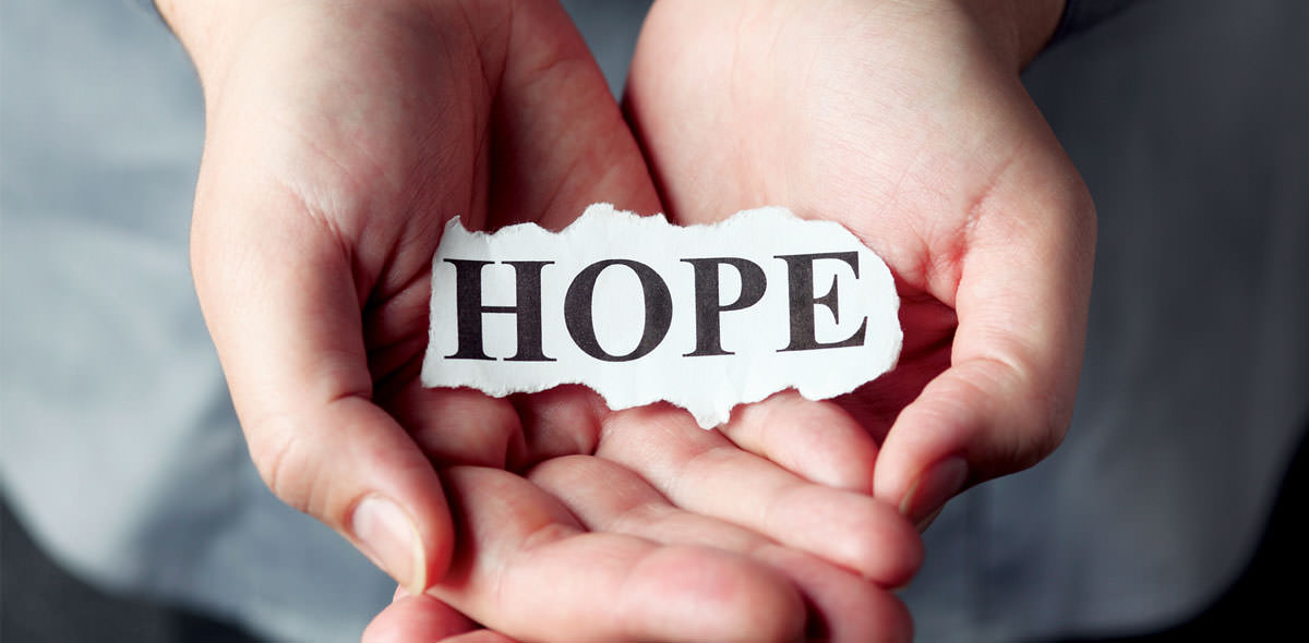 Hope on piece of paper held in hands