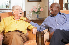 Two senior man sitting and laughing