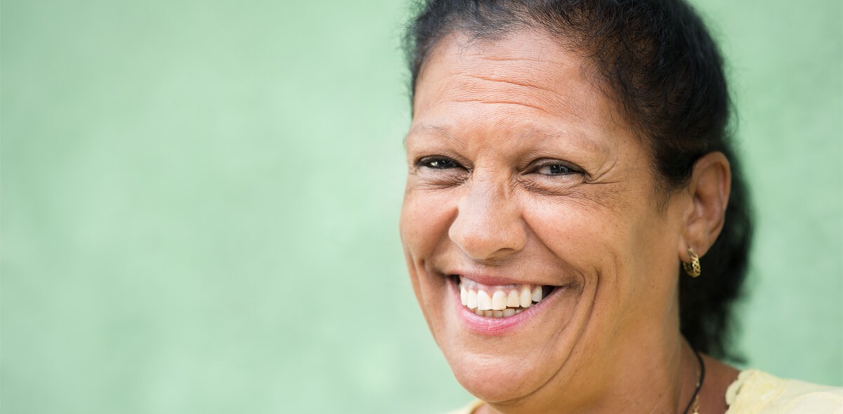 Hispanic woman smiling green background