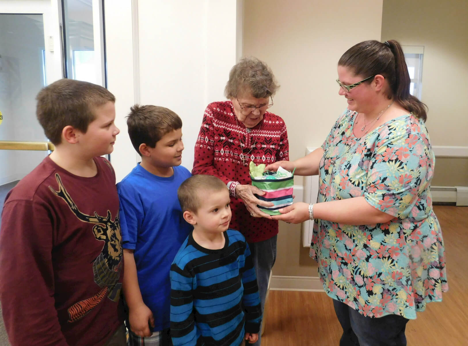 Westwood Commons resident Florence VanCott receives a basket from Lori and her sons 