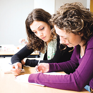 Two women filling out paperwork