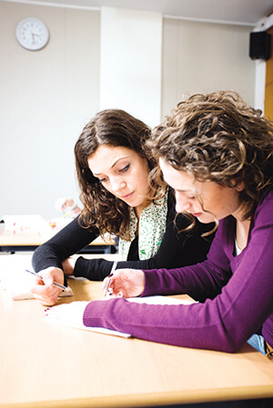 Two women filling out paperwork