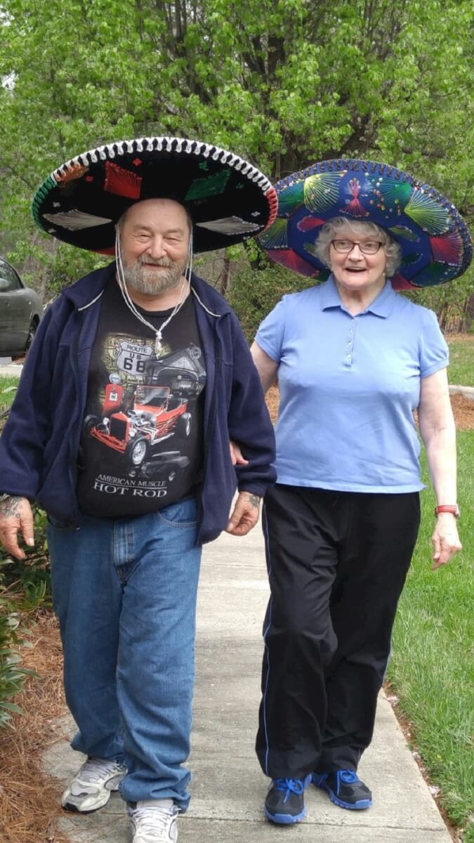 Twelve Oaks residents Randy Newman and Brenda Edmonds walking around the community wearing sombreros 