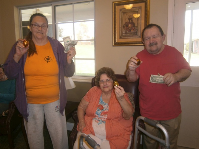 Brenda Parker, Dora Jones and Roger Green proudly display their winnings from their golden eggs.