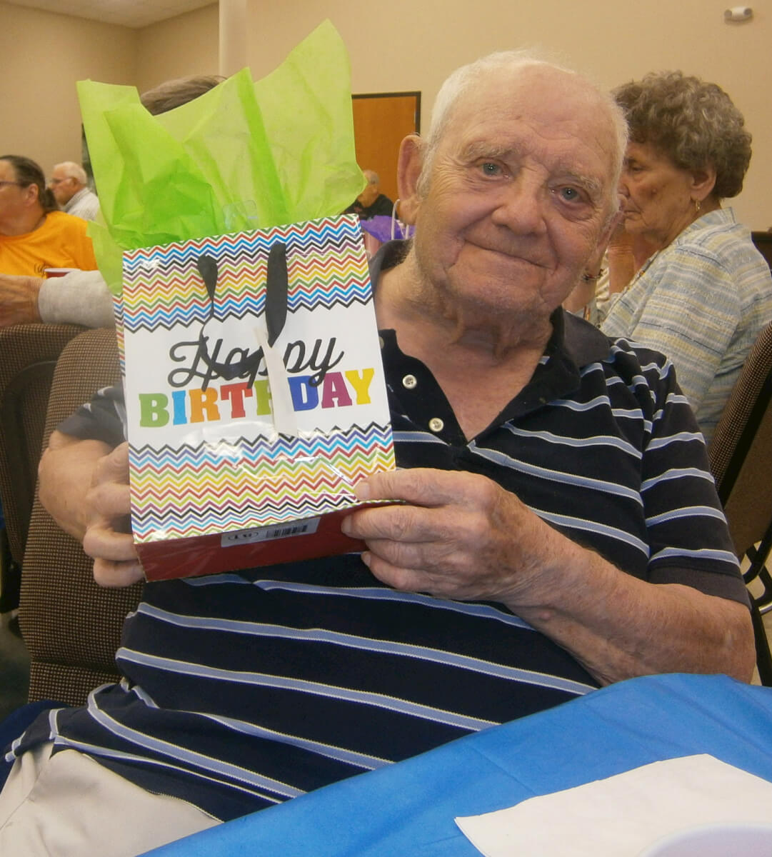 Heath House resident Ben Pepitone receives a present at the 2nd Annual Magical Birthday Party