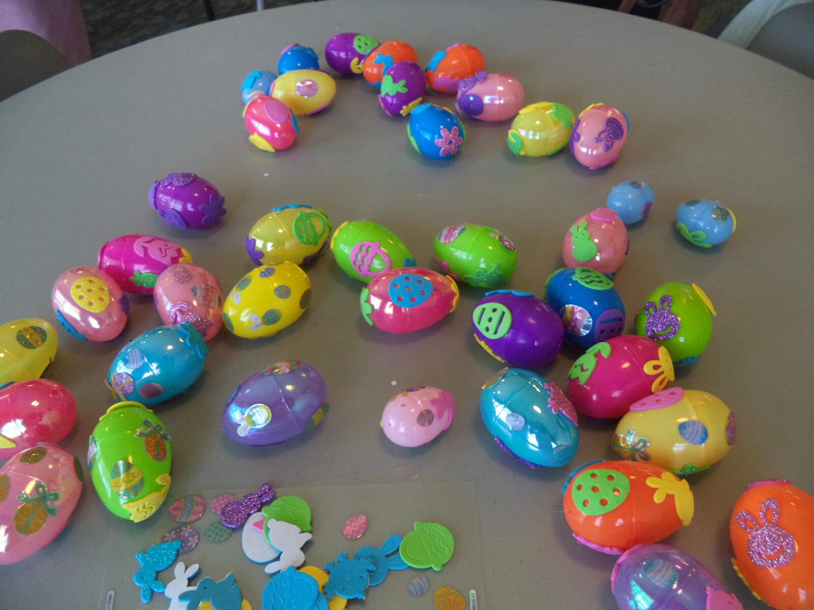 Decorated plastic Easter eggs of various bright colors and stickers 
