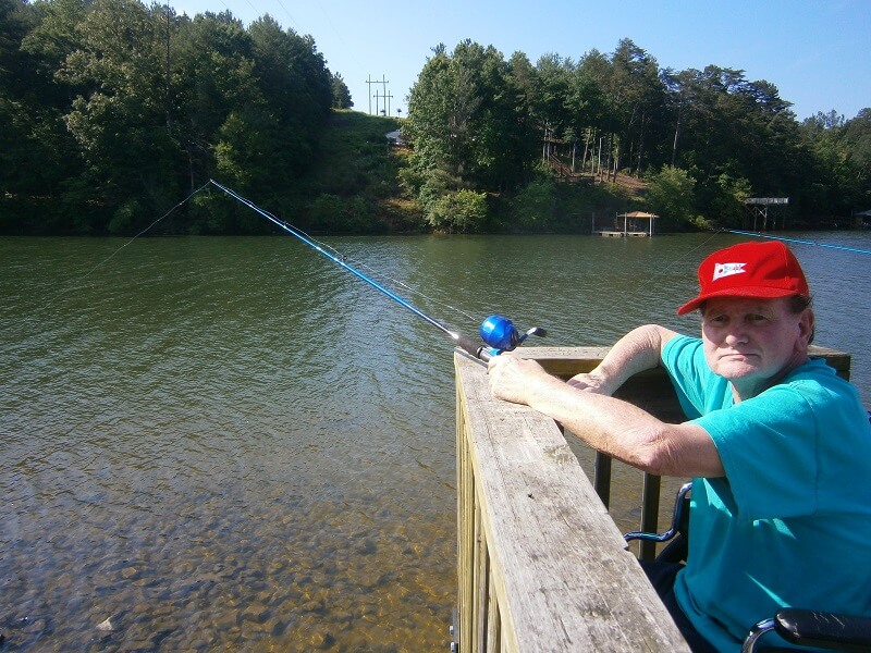 Cambridge House resident John Riley casting his line into the Catawba River