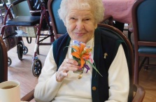 Westwood Commons resident Elaine Koch with a flower