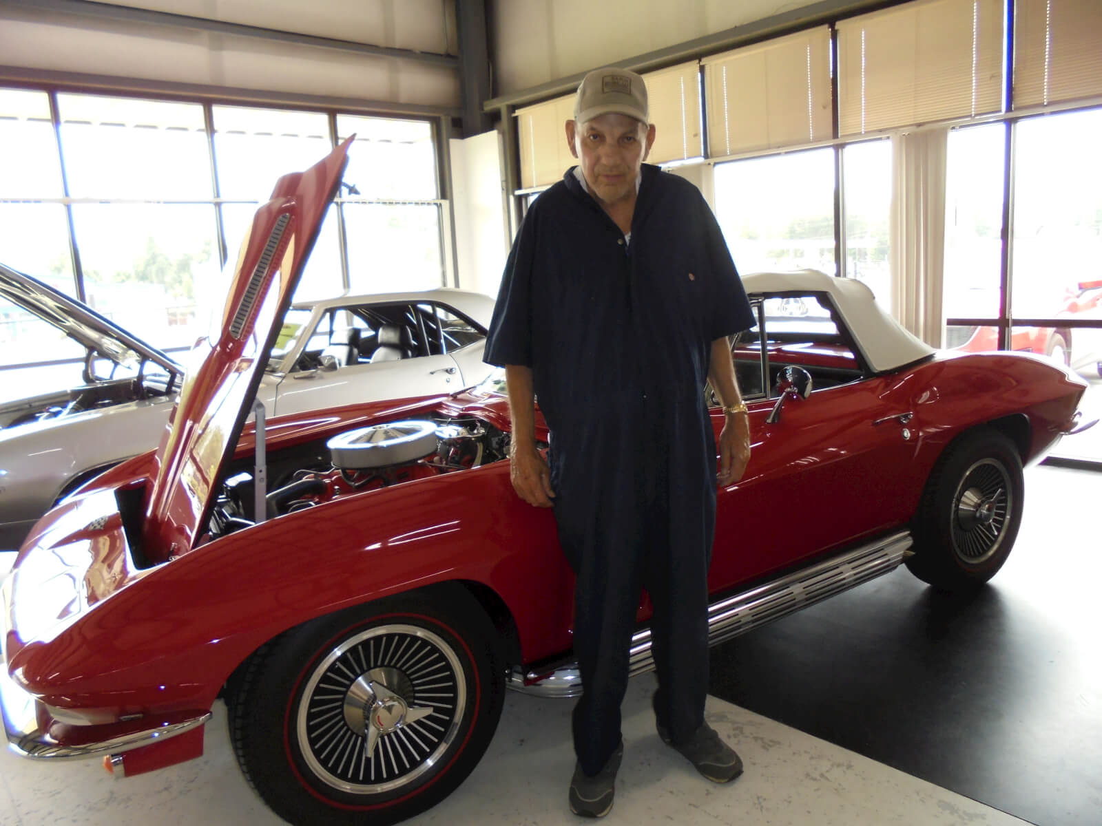 Oakview Commons resident Durwood Nichols posing with a classic car