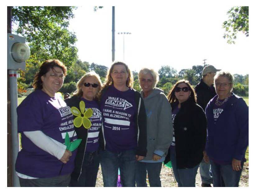members of Twelve Oaks team Med Tech Rosalie Sexton, Resident Care Coordinator Johnnie Holt, Memory Care Coordinator Alicia Lambert, Supervisor Penny Joyce, Administrator Penny Haynes and Administrative Assistant Anne Burkhart posing for a photo at the walk