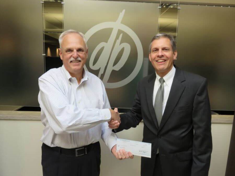 Vice President of Commercial Real Estate for First Niagara John Berry presents a grant to DePaul President Mark Fuller