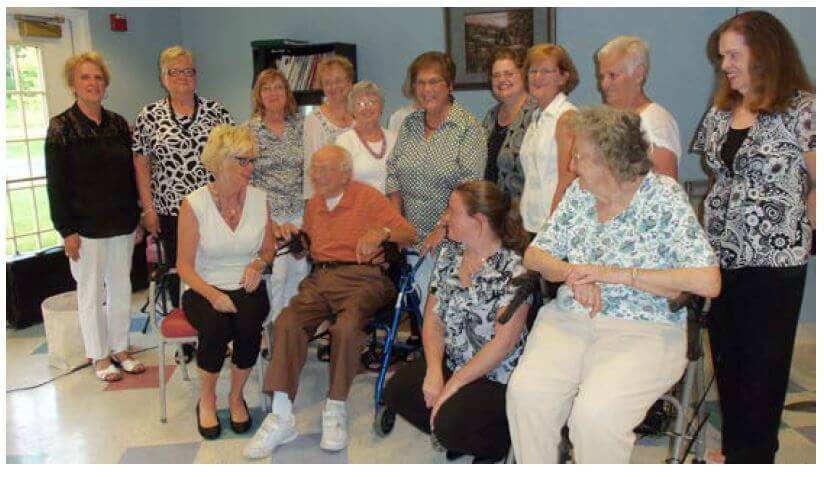 For Singing’s Sake, an all-female vocal ensemble with members from Spencerport, North Chili posing for a photo with Westwood Commons residents