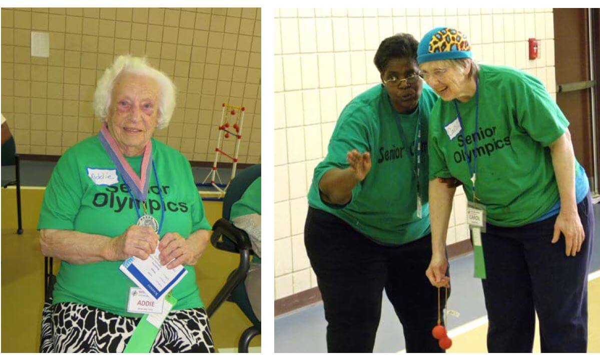 Westwood Commons resident Adelaide Swetz shows off a medal she earned in the bean bag toss while resident Carole Rath gets pointers from Westwood Commons Activities Director Cathy Toney in the ladder ball event