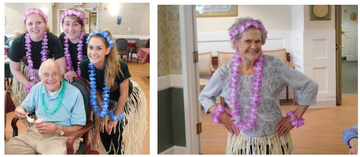 Westwood Cooks Amanda Ball and Kiera Morgan, Dietary Aide Laura Manthei and resident Frank DiNitto and Anna Bell dressed in lei's and Hawaiian skirts