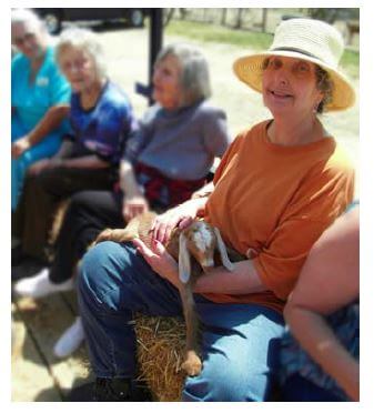 Woodridge Resident holding a baby goat at the zoo