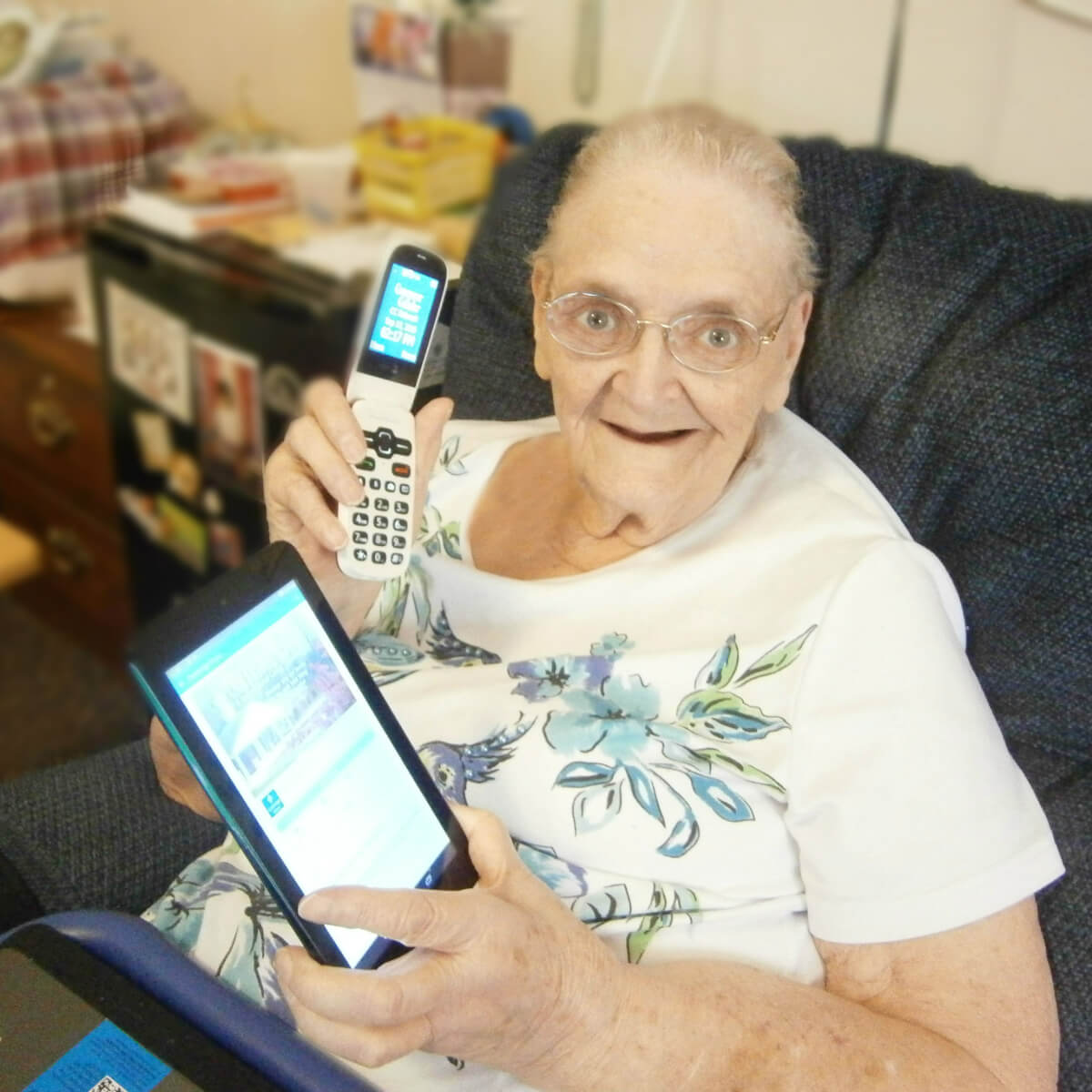 Kate Hagaman, a resident at Cambridge House, a DePaul Senior Living Community with her cell phone and tablet
