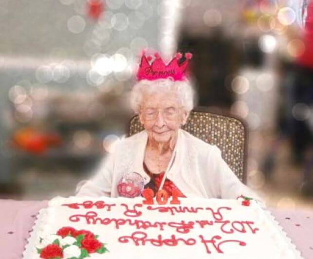 Twelve Oaks resdient Annie Riggs blowing out her 102nd birthday cake candles 
