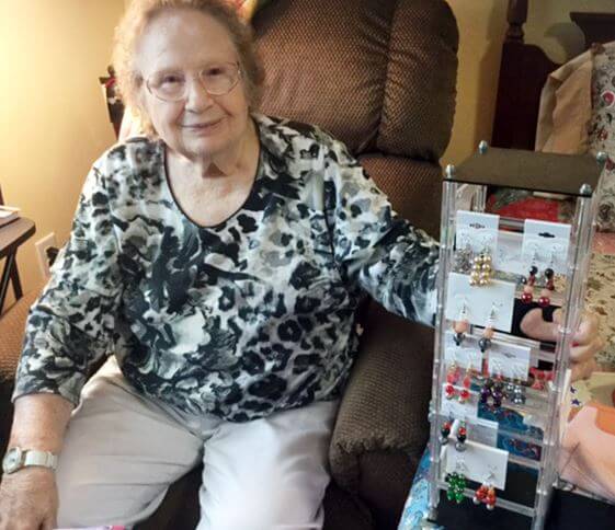 Prestwick Village resident Lucille Capps posing with the earrings she makes