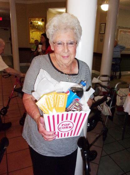 A resident with their winning movie themed raffle basket 