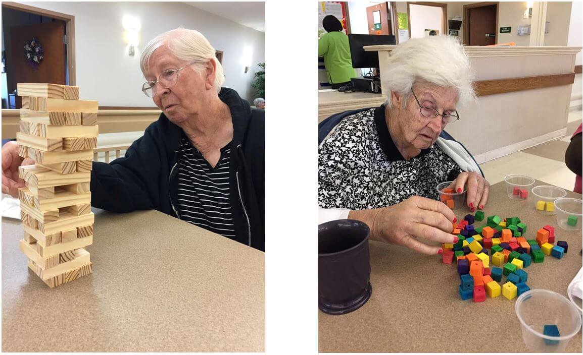 Residents playing Jenga and sorting colored cubes 