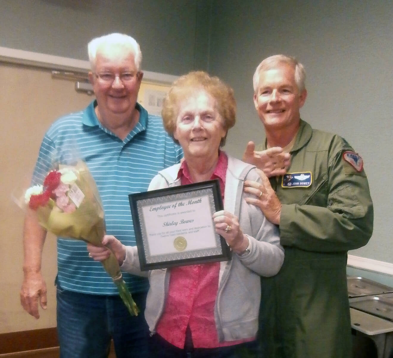 Shirley Barnes, a resident of Twelve Oaks with her husband and son after winning employee of the month