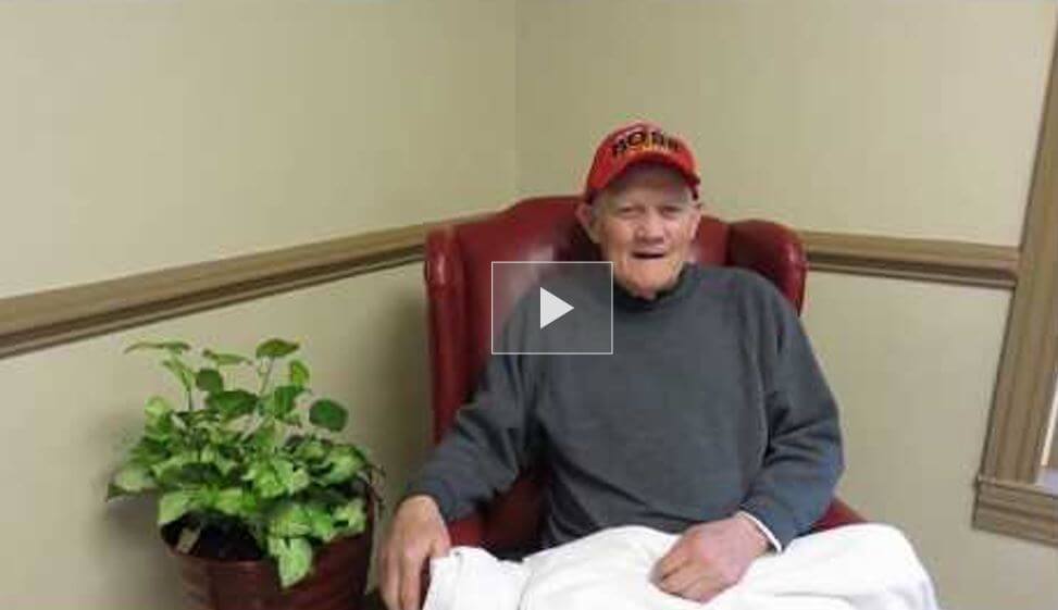 Pete Bowman, a resident of Twelve Oaks sitting in a chair