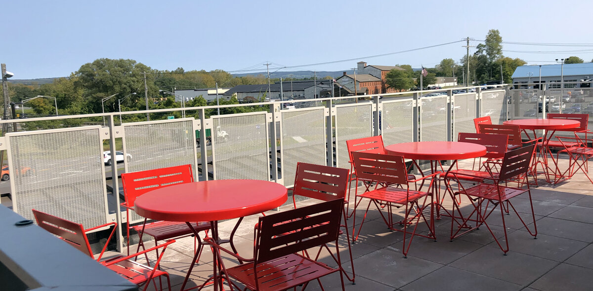 Red balcony seating at the Starting Line Apartments