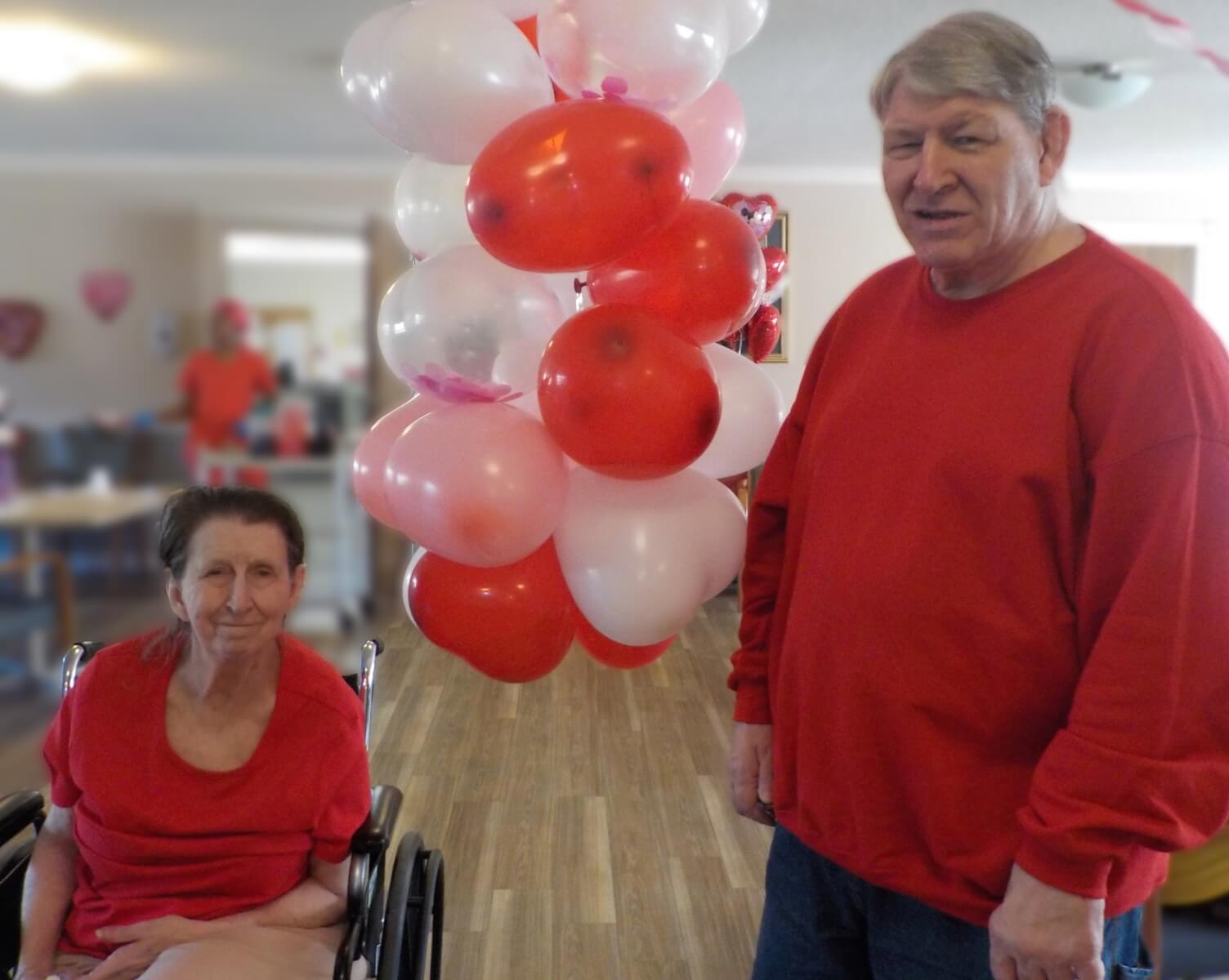 Residents Wanda Rowland and Gerald Miller posing with Valentine's Day Balloons