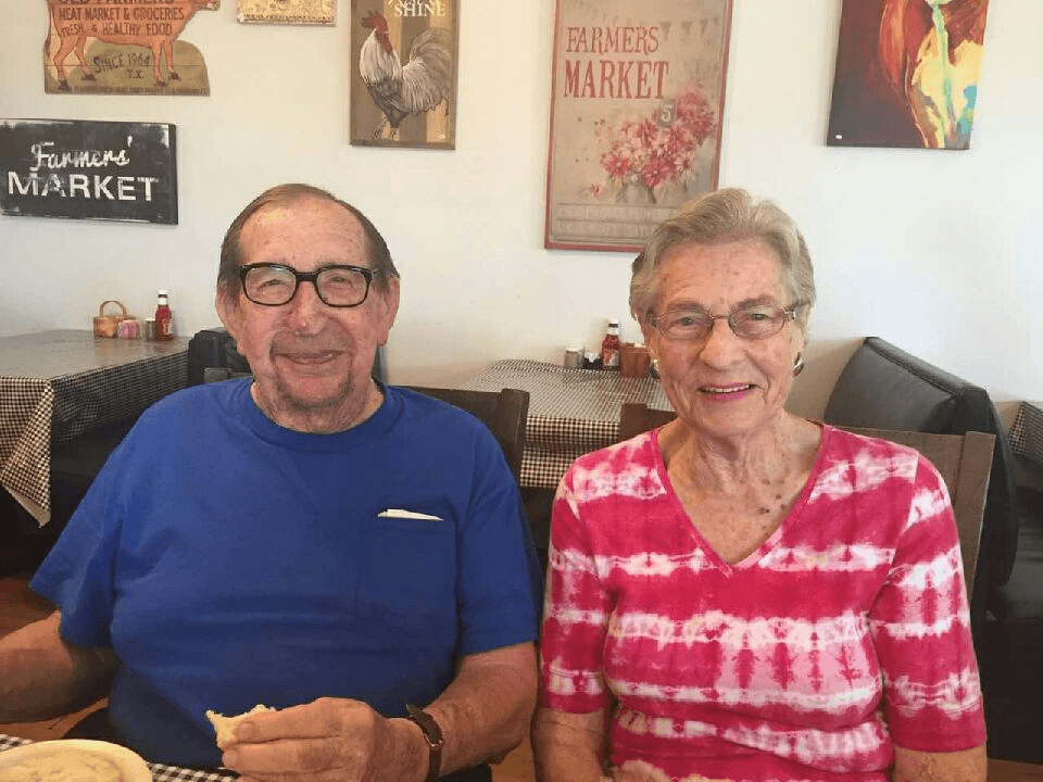 elderly couple sitting next to each other