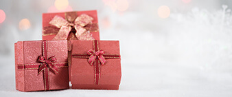Three red gift boxes on a blurry background