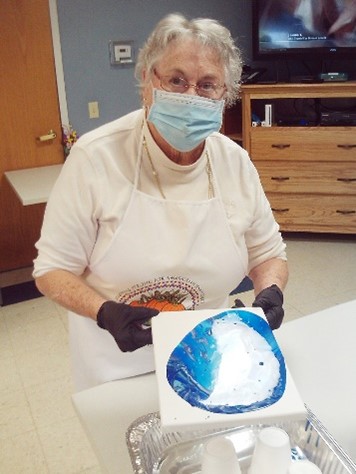 Louise Huck works on a paint pouring craft. 