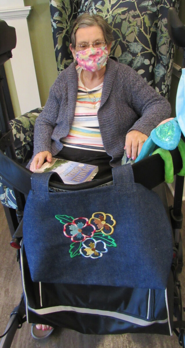 Donna Parker enjoys some summer reading and a beautiful, durable denim walker bag