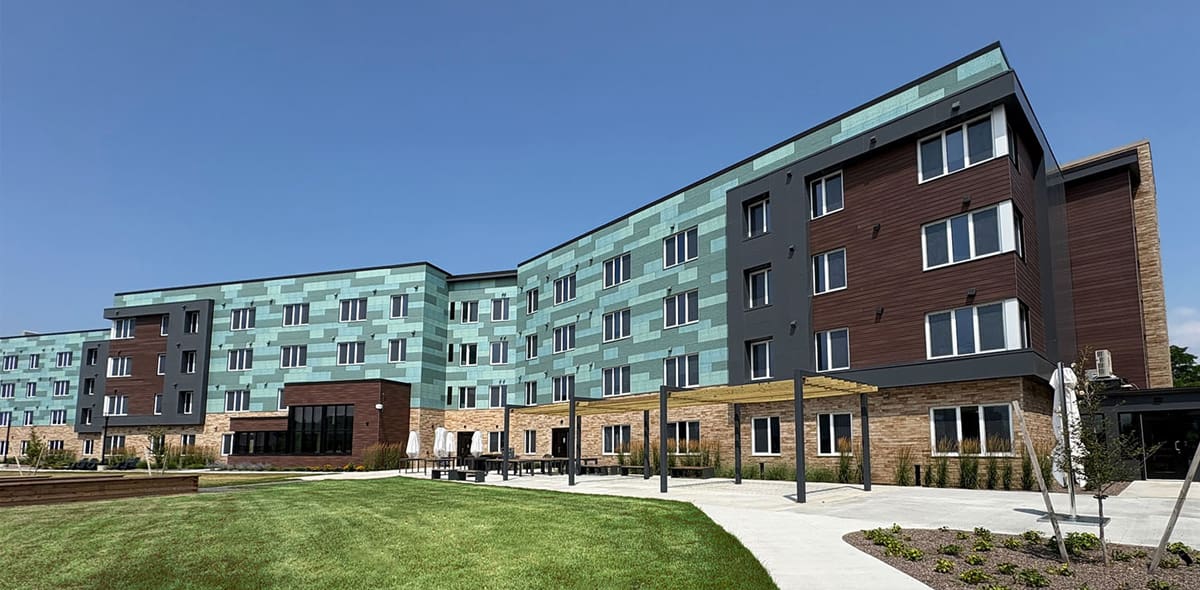 Green and brown exterior of building with blue sky