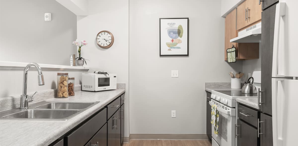 Kitchen with sink, stove, and fridge