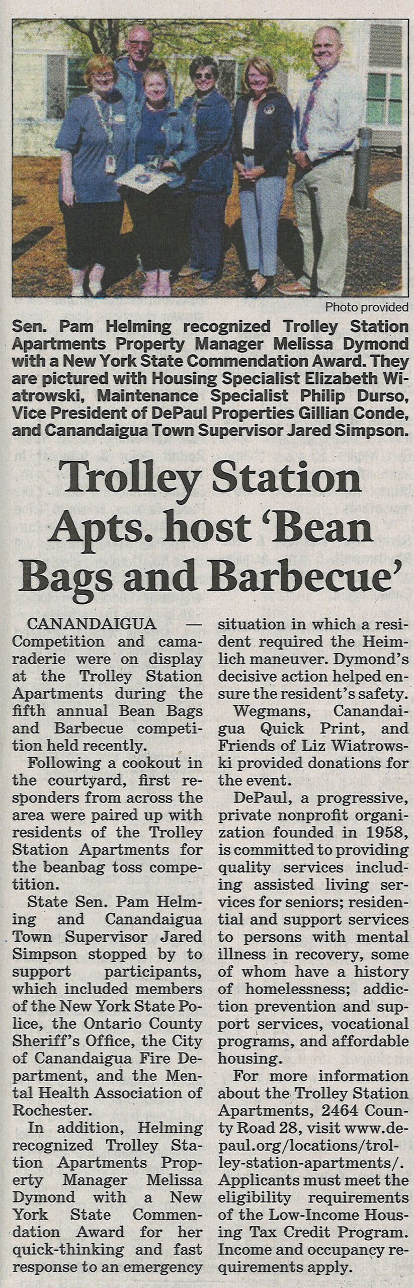 News article and photo of award presentation including six people. 