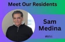 A man in a black jacket stands in front of a window. The image has a blue and green background with the text Meet Our Residents and Sam Medina next to the photo.